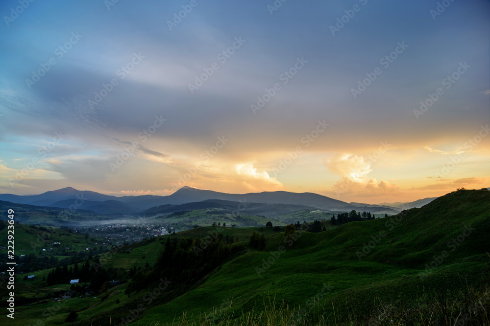 Sunset against the backdrop of mountains and wildlife. Nature, travel, tourism