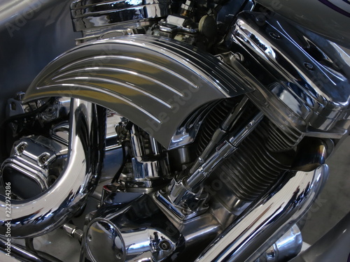 Chrome motorcycle engine parts close-up.  The engine and exhaust system in chrome of the motorcycle. © Aleh