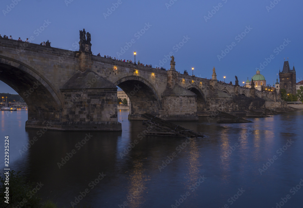 View of iluminated Charles Bridge in from Kampa, Czech Republic. Gothic Charles Bridge is one of the most visited sights in Prague. Architecture and landmark of Prague, night blue hour after sunset