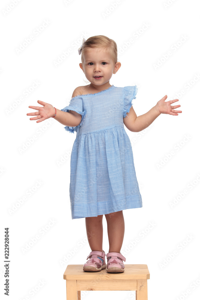 smiling little beautiful girl standing and showing her hands