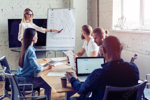 Working hard to win. Businesswoman conducting a business presentation using flipchart while working in the creative office.