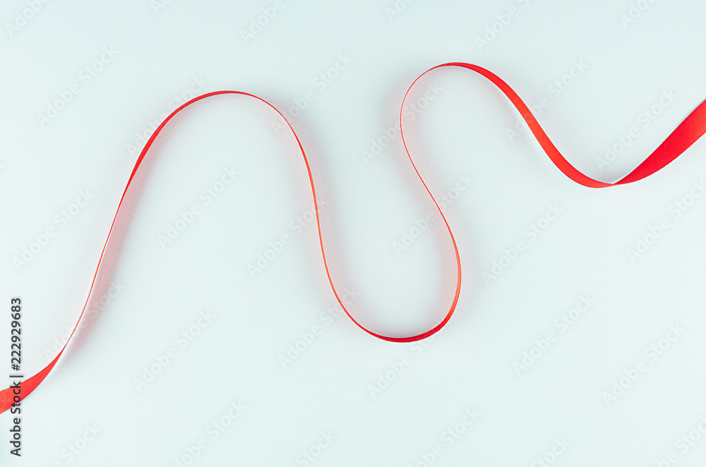 Red tape as motion energy wave abstract on trendy mint color background.
