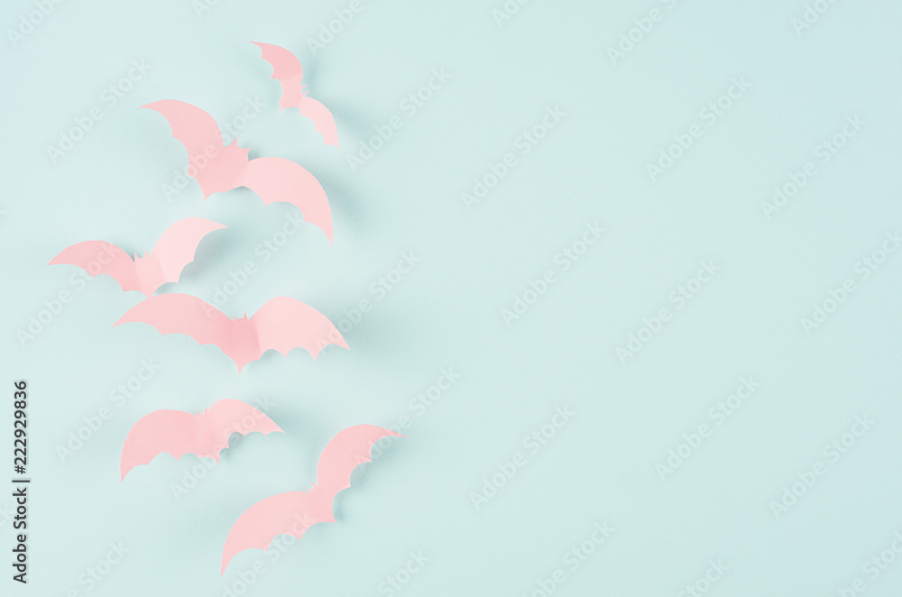 Fototapeta Halloween concept art of cut paper - pink soar bats on candy mint blue background, copy space.