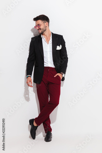 attractive smart casual man looks to side and smiles