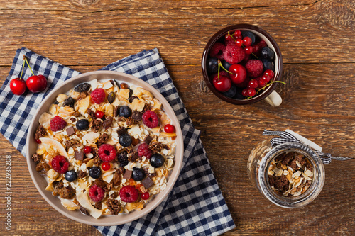 Breakfast, muesli with milk and fresh fruit.