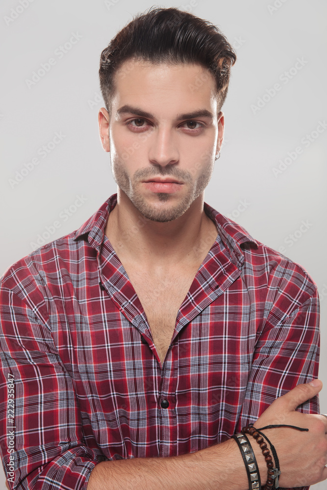confident casual man standing with hands crossed confident casual man standing with hands crossed