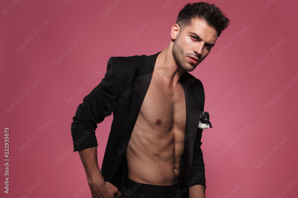 portrait of confident handsome man wearing undone black tuxedo portrait of confident handsome man wearing undone black tuxedo