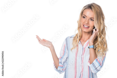 woman talking on smartphone and showing something isolated on white