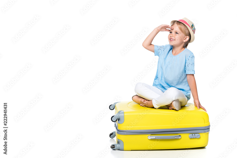smiling child sitting on yellow baggage isolated on white smiling child sitting on yellow baggage isolated on white