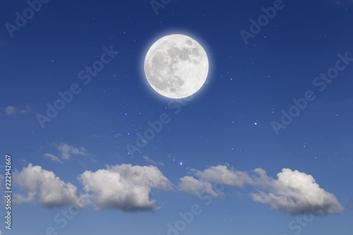 Romantic night with full moon in space over stars with cloudscape background.