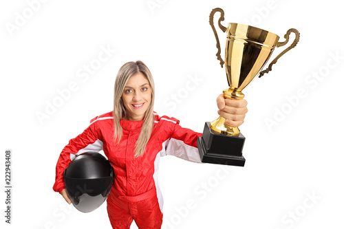 Woman racer in a suit holding a gold trophy cup