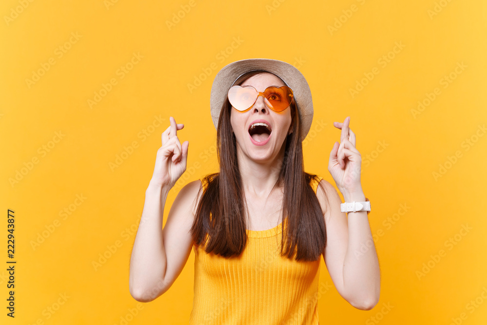 Uventet rygte sympatisk Waiting for special moment. Portrait of smiling happy woman in orange  glasses keeping fingers crossed. Making wish. Copy space isolated on yellow  background. People sincere emotions lifestyle concept. Stock Photo | Adobe
