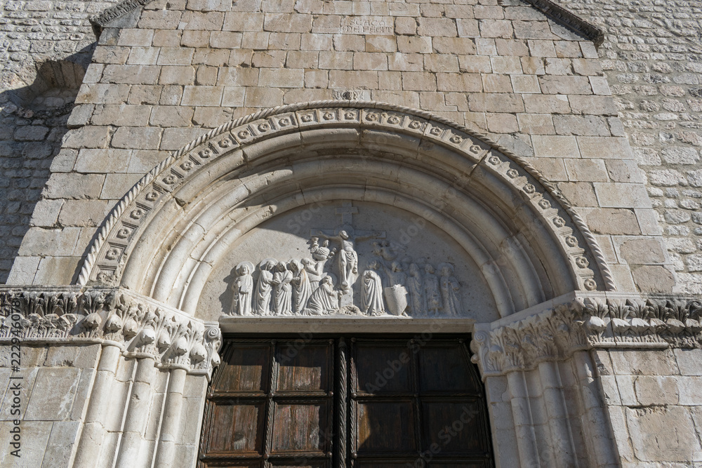 Detail of the front of a traditional old italian church in the street of n italian city