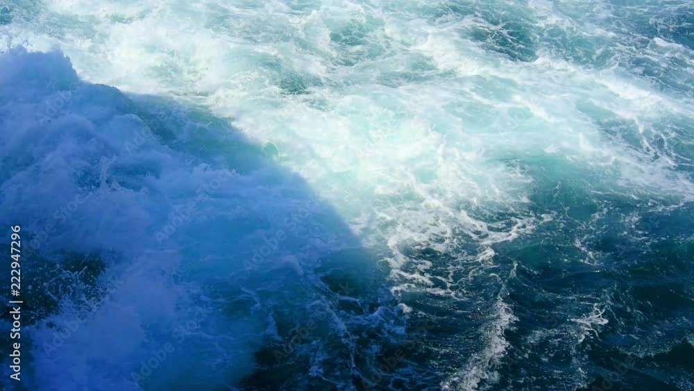 White foaming sea water comming out from ferry boat jet powered engine