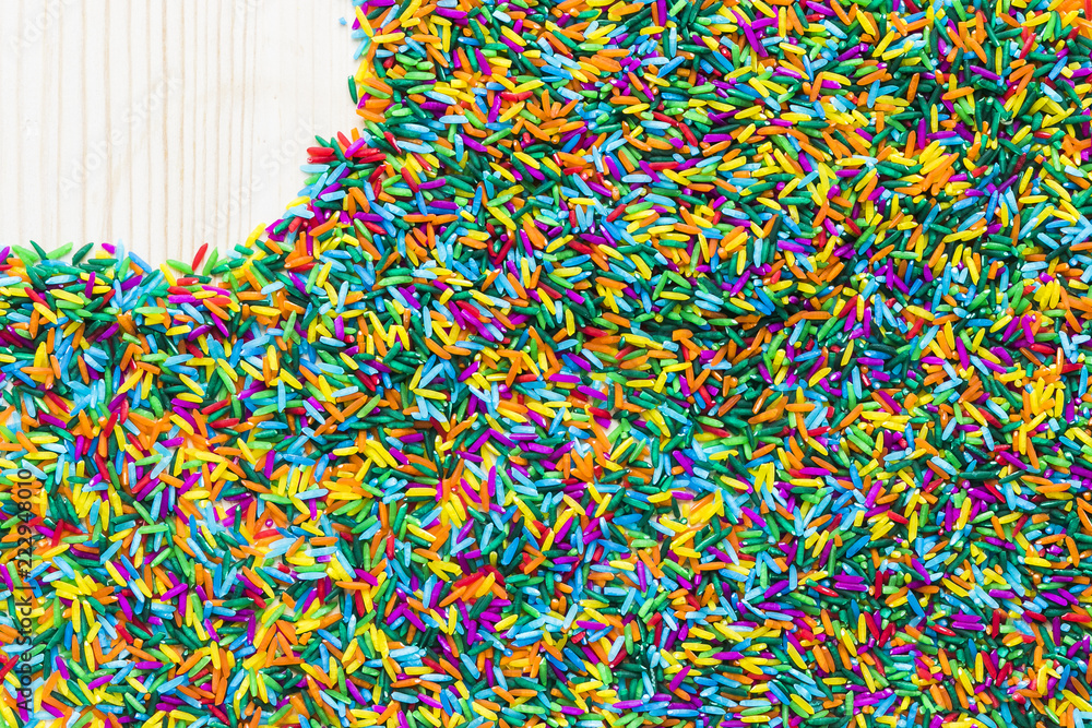 Fototapeta premium Left Copyspace on colorful rice on wooden background