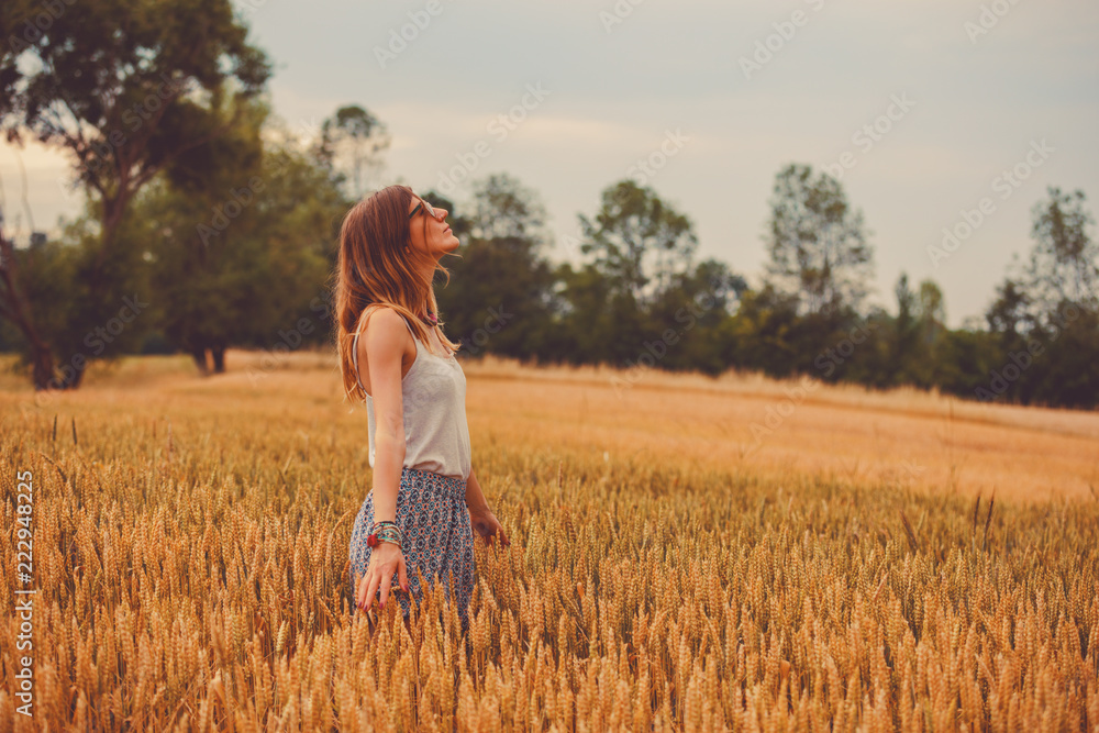 Girl enjoying in a golden wheat - field in the summer. Girl enjoying in a golden wheat - field in the summer.