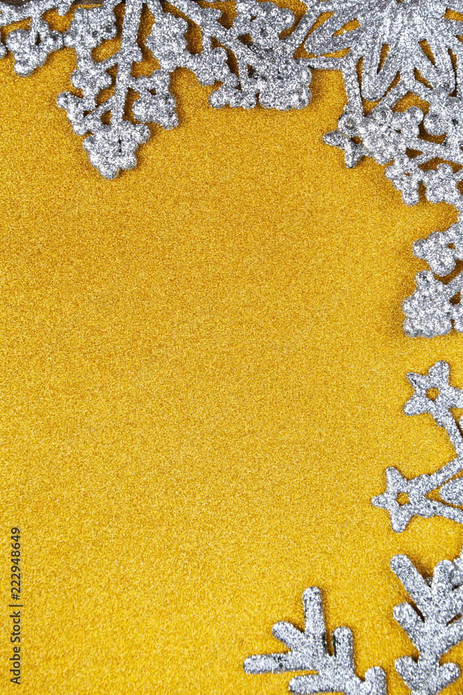 Silvery snowflakes on a yellow  background