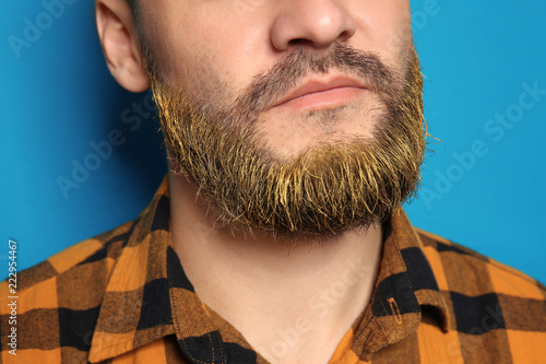 Handsome man with dyed bear...