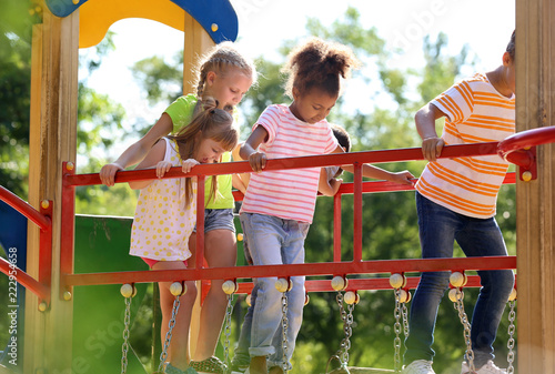 Canvas Print Cute little children having fun on playground outdoors