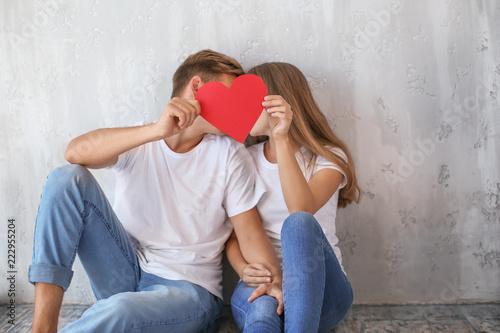 Happy young couple hiding f...