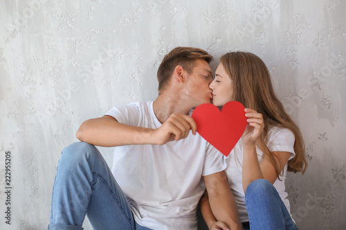 Happy young couple with red...
