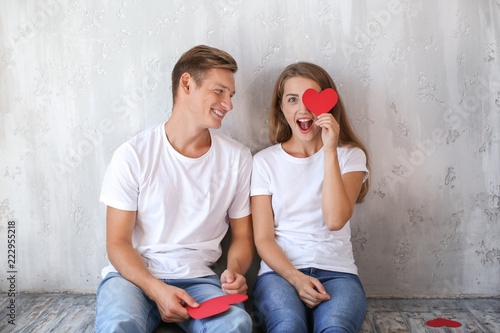 Happy young couple with red...