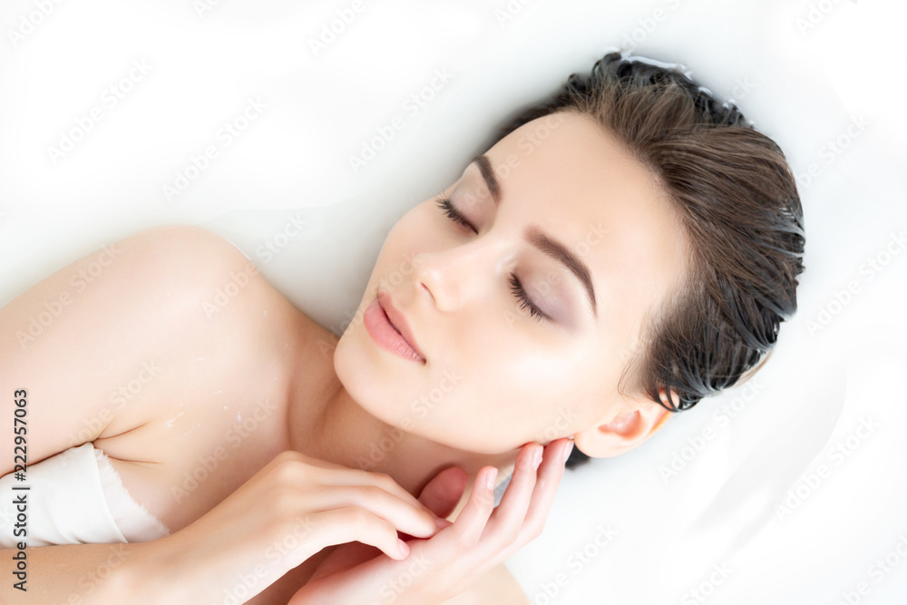 Portrait of young sexy beauty Caucasian female woman adult with clean pure skin taking spa relaxing in bath with white soap shampoo water. Skin beauty health care concept. Body part bare shoulder Portrait of young sexy beauty Caucasian female woman adult with clean pure skin taking spa relaxing in bath with white soap shampoo water. Skin beauty health care concept. Body part bare shoulder