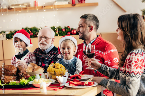 happy big family with wine having christmas dinner at home