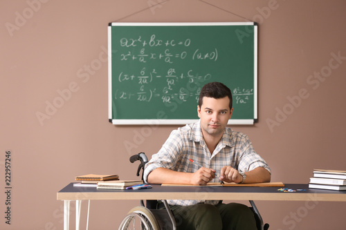 Male teacher in wheelchair ...