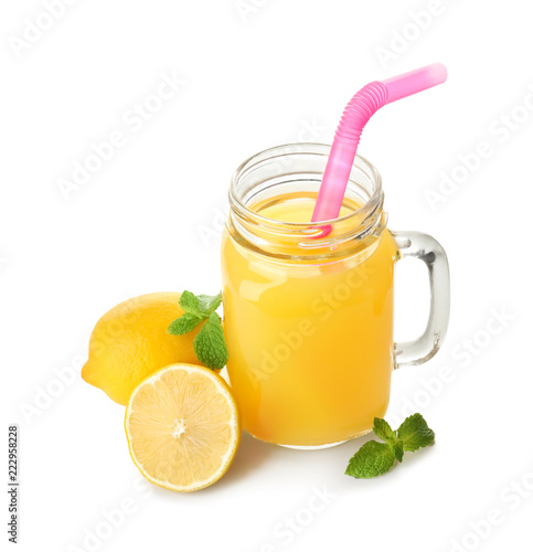 Mason jar of fresh lemon juice on white background