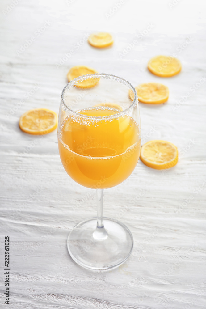 Glass of fresh lemon juice on white wooden table Glass of fresh lemon juice on white wooden table