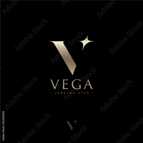 Vega letter. Vega star astronomy logo. Gold letter V with star. Jewelry emblem. Optical illusion gold monogram. Gold V logo on a dark background. Monochrome option. photo