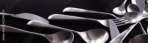 fork spoons knives background / beautiful serving tableware