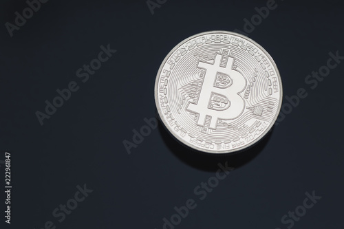 Bitcoin cryptocurrency coin token close up cleaned silver macro with black background and copy space.