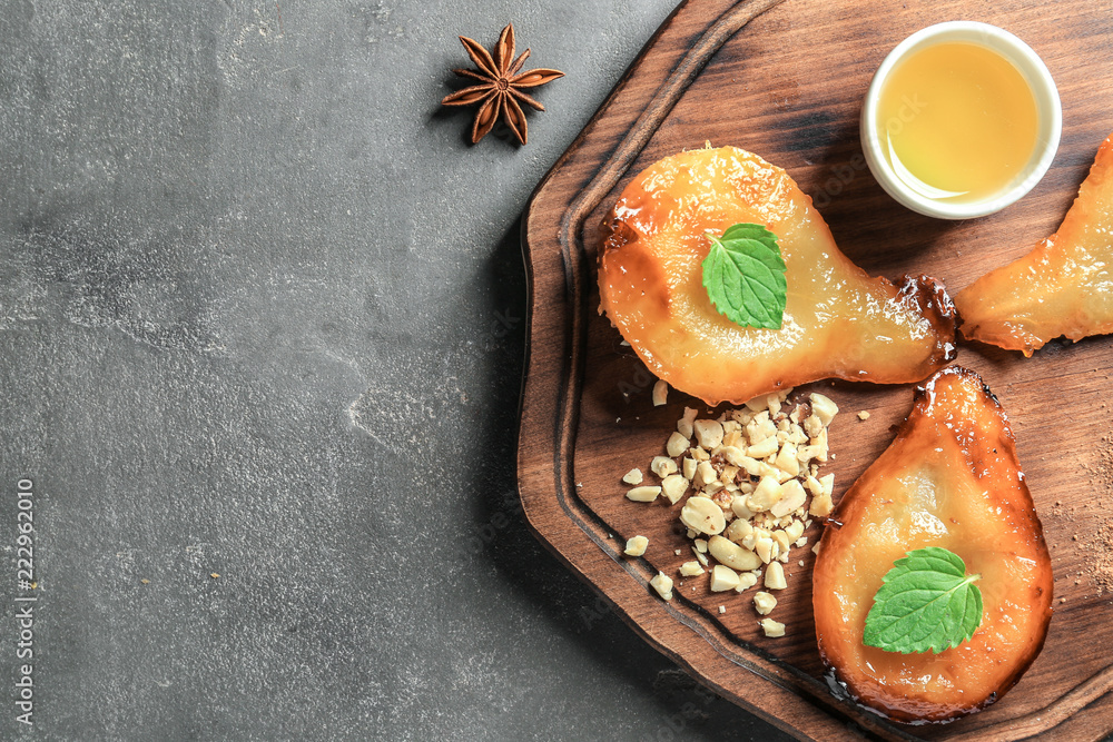 Halves of tasty baked pears with honey on wooden board Halves of tasty baked pears with honey on wooden board