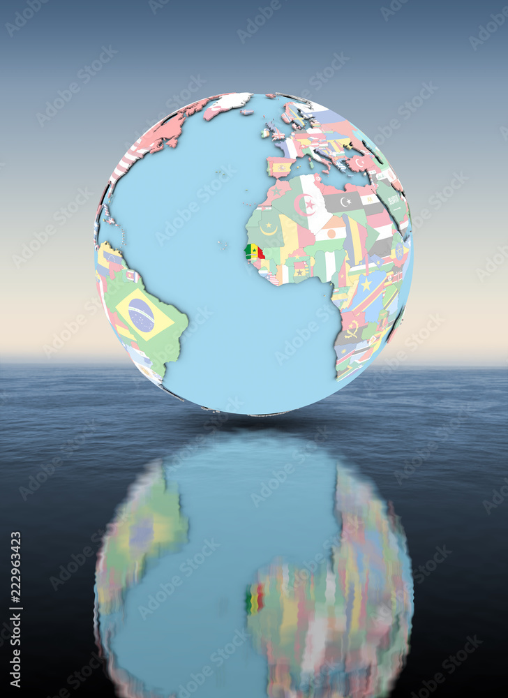 Fototapeta premium Senegal on globe with flags above water surface