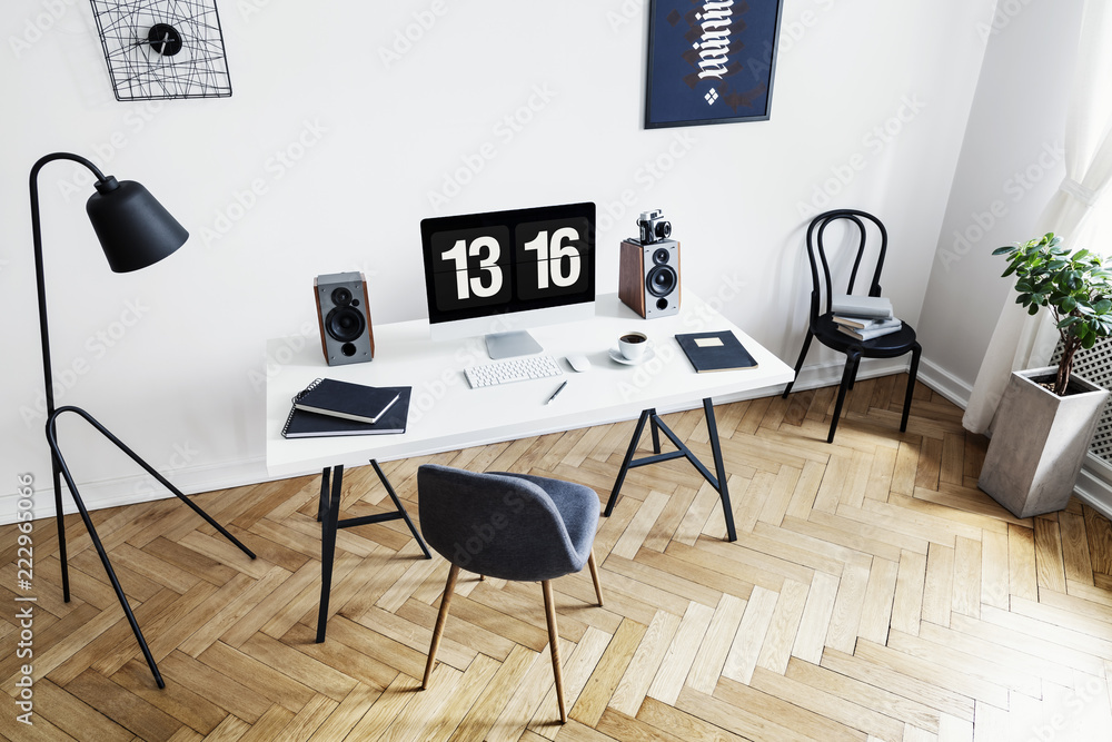 High angle view of a bright home office interior for a creative professional with black and white furniture and herringbone parquet floor. Real photo. - obrazy, fototapety, plakaty 