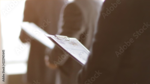close up.businessman with a clipboard on the background of colleagues