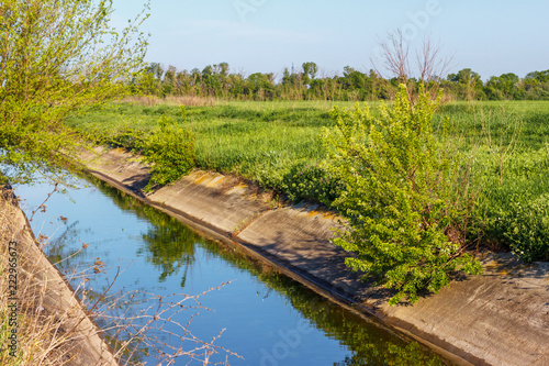 The concrete channel for agriculture irrigation in the farmland photo