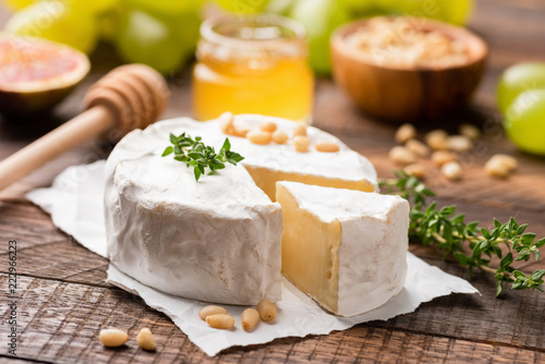 Camembert or Brie cheese served with honey, pine nuts, grapes and figs.