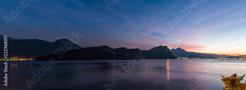 Large magnificent night panorama extra wide. XL Switzerland. Large night panorama of Lake Lucerne. Mountains in the evening sunset. In the background, the lights of the city of Lucerne.