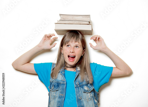 portrait of young teenage girl with books on white background