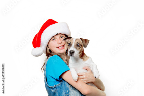 portrait of young teenage girl in Christmas hat with jack russell terrier dog on white background