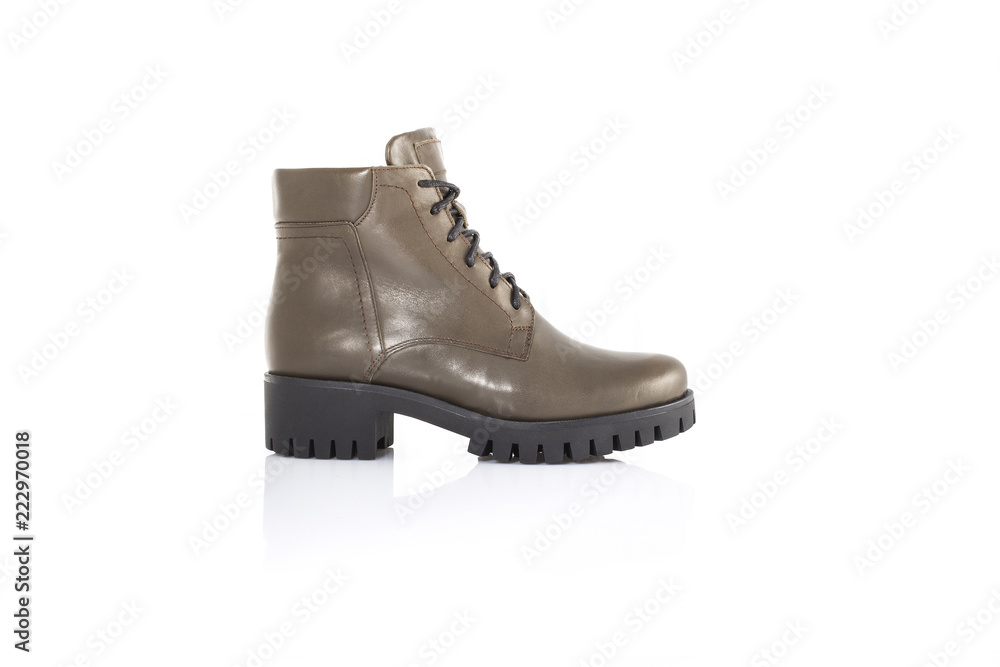 Close up of a gren women boots shoes on white background with reflection. Fashion advertising shoes photos. Close up of a gren women boots shoes on white background with reflection. Fashion advertising shoes photos.