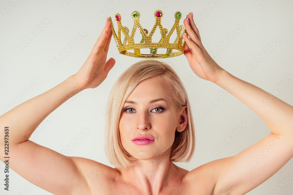 Beauty queen woman blonde put on placing tiara crown on head high self  esteem selfishness studio white background Stock Photo | Adobe Stock