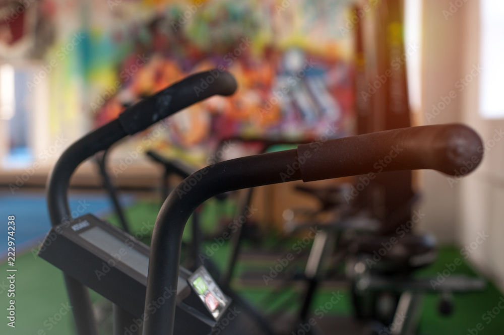 Air bikes for intense cardio workout in the crossfit gym. Sports and fitness concept. Air bikes for intense cardio workout in the crossfit gym. Sports and fitness concept.