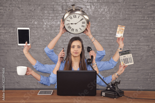 multitask businesswoman sat at the desk in the office, concept of well organized work photo