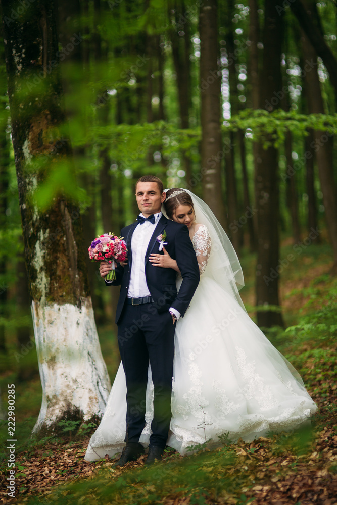 Romantic couple of newlyweds in the middle of forest Romantic couple of newlyweds in the middle of forest