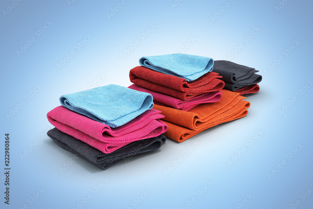 Pile of colored towels isolated on blue gradient background 3d Pile of colored towels isolated on blue gradient background 3d