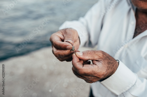 Hands preparing plummet for fishing